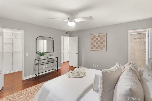 a bedroom with a bed and dresser with mirror