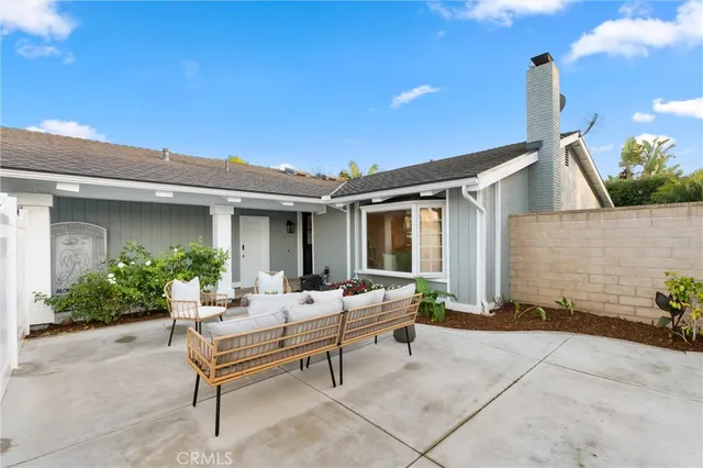 a view of a house with backyard sitting area and garden