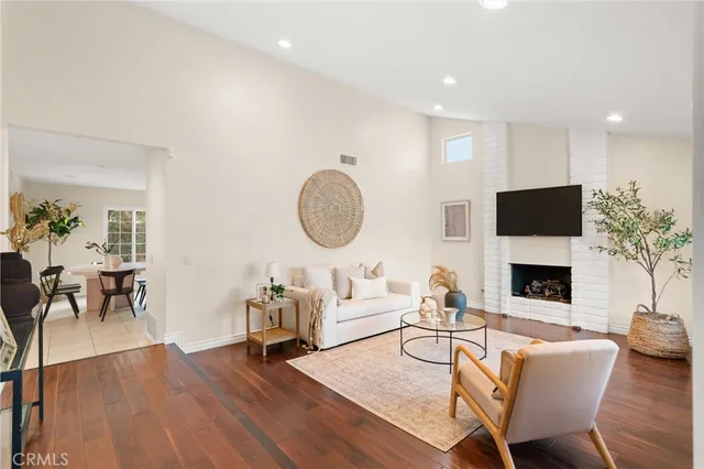 a living room with fireplace furniture and a flat screen tv