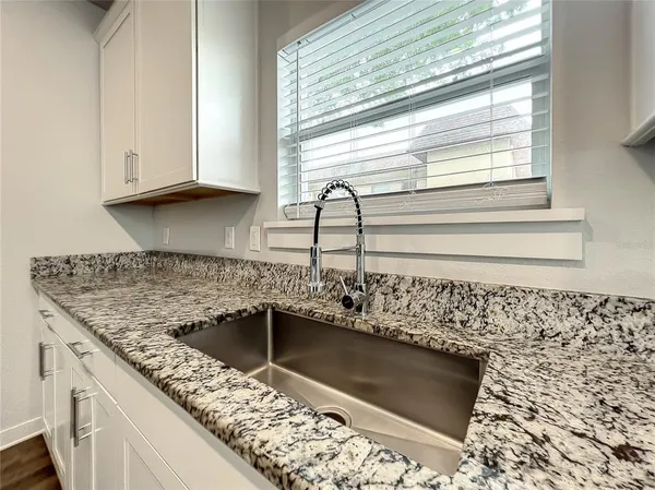 a kitchen with a sink and cabinets