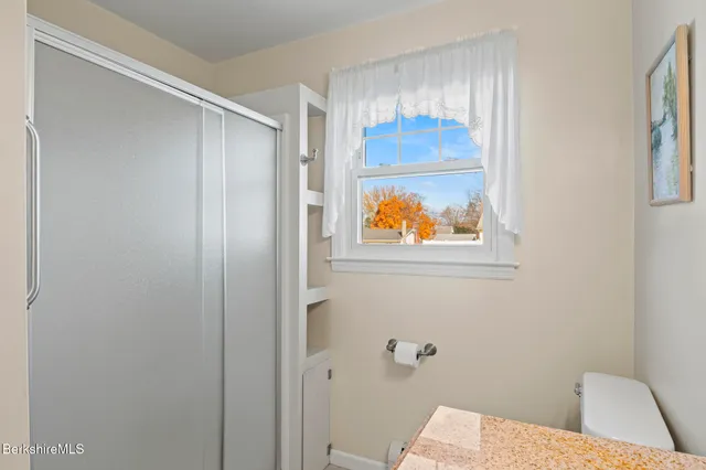 a bathroom with a window and a shower