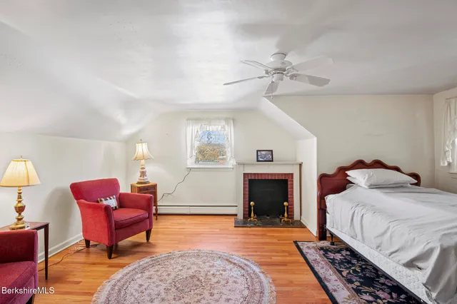 a bedroom with furniture and a fireplace