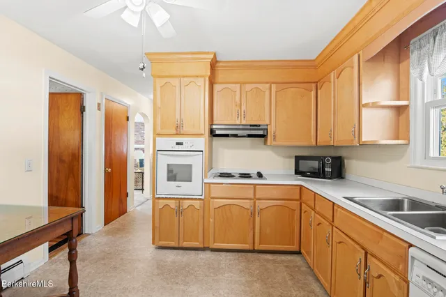 a kitchen with stainless steel appliances granite countertop a refrigerator sink and cabinets