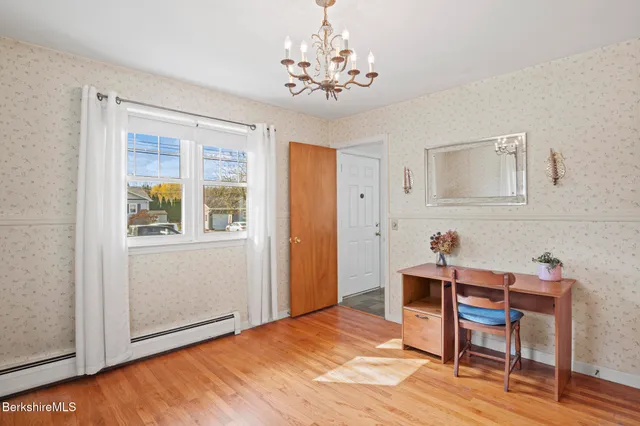 a workspace room with a bed and a chandelier