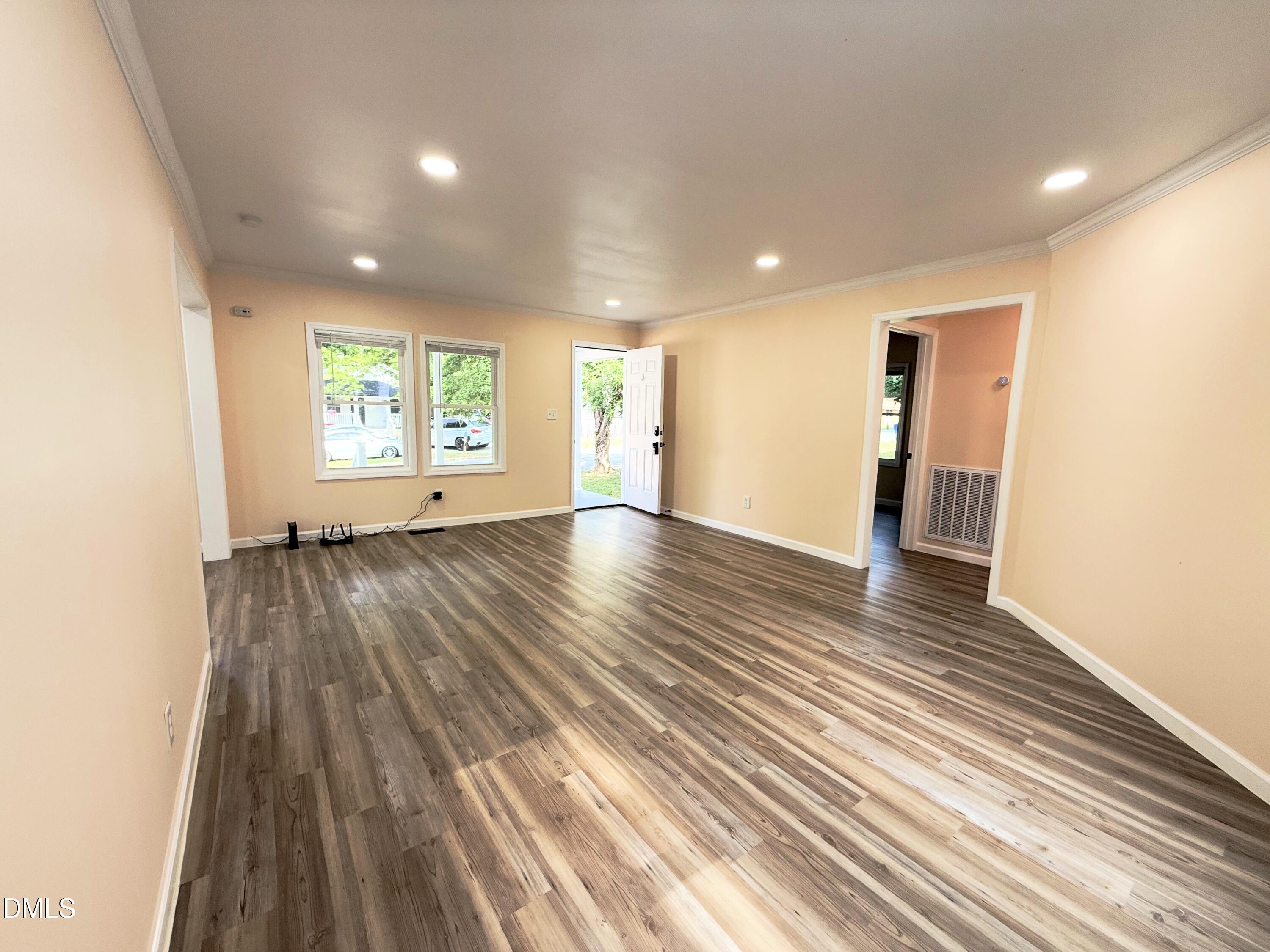 417 North Street Graham, NC 27253 - Photo 10 of 18 an empty room with wooden floor and windows
