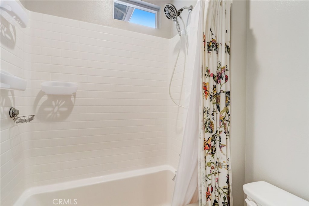 193 Stonegate Road Camarillo, CA 93010 - Photo 20 of 39 a bathroom with a shower curtain and a toilet