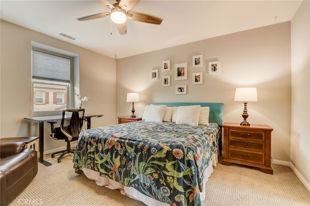 193 Stonegate Road Camarillo, CA 93010 - Photo 22 of 39 a bedroom with a bed and a chandelier