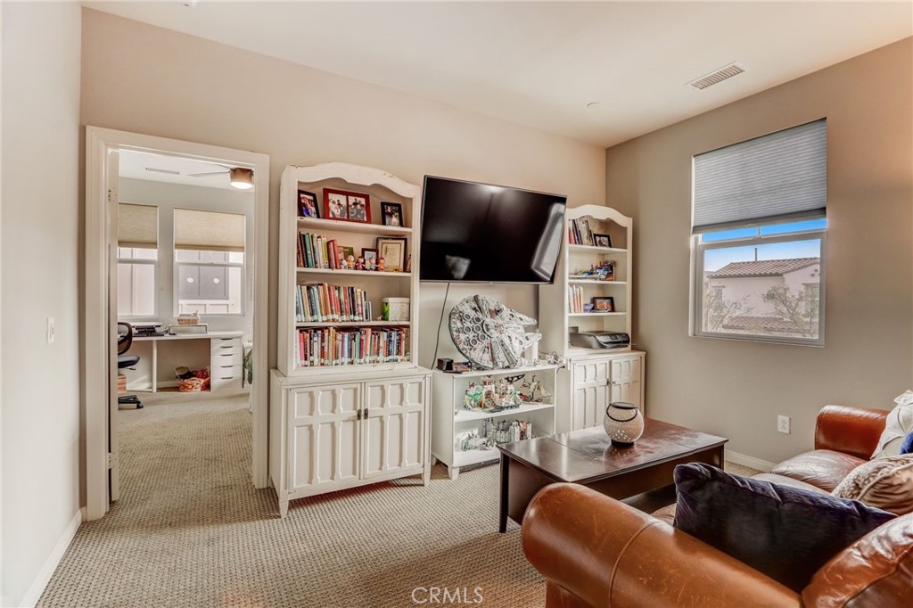 193 Stonegate Road Camarillo, CA 93010 - Photo 31 of 39 a living room with furniture a rug and a flat screen tv
