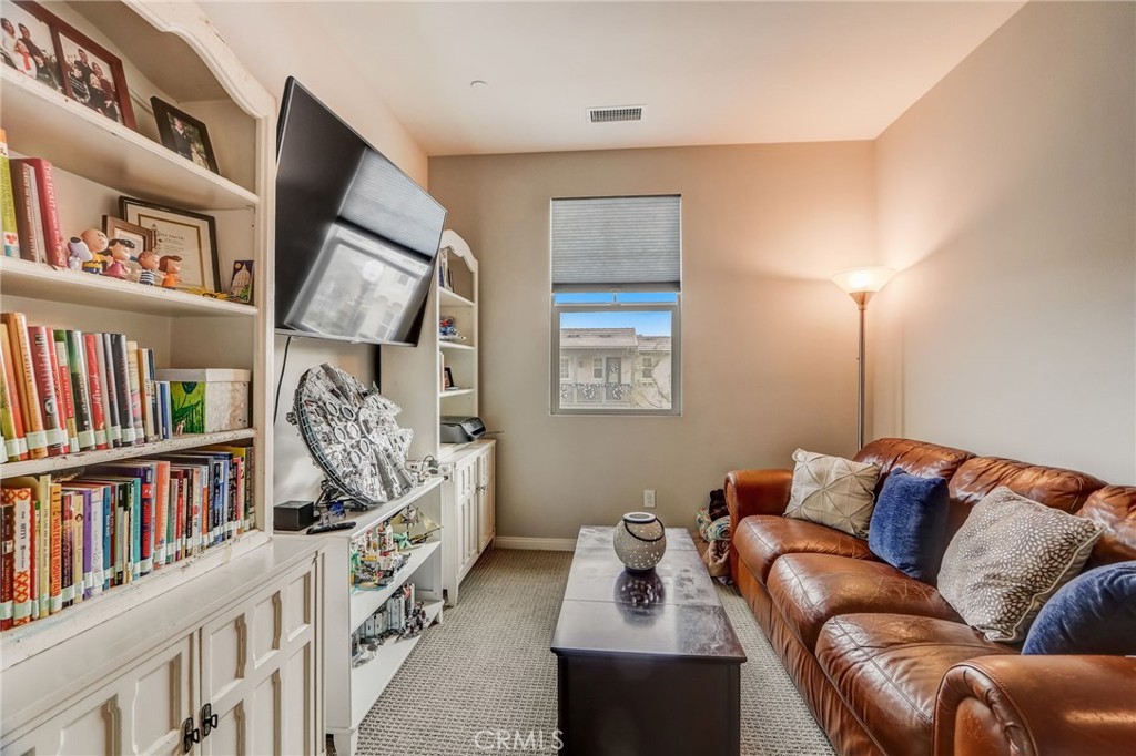 193 Stonegate Road Camarillo, CA 93010 - Photo 32 of 39 a living room with furniture and a book shelf