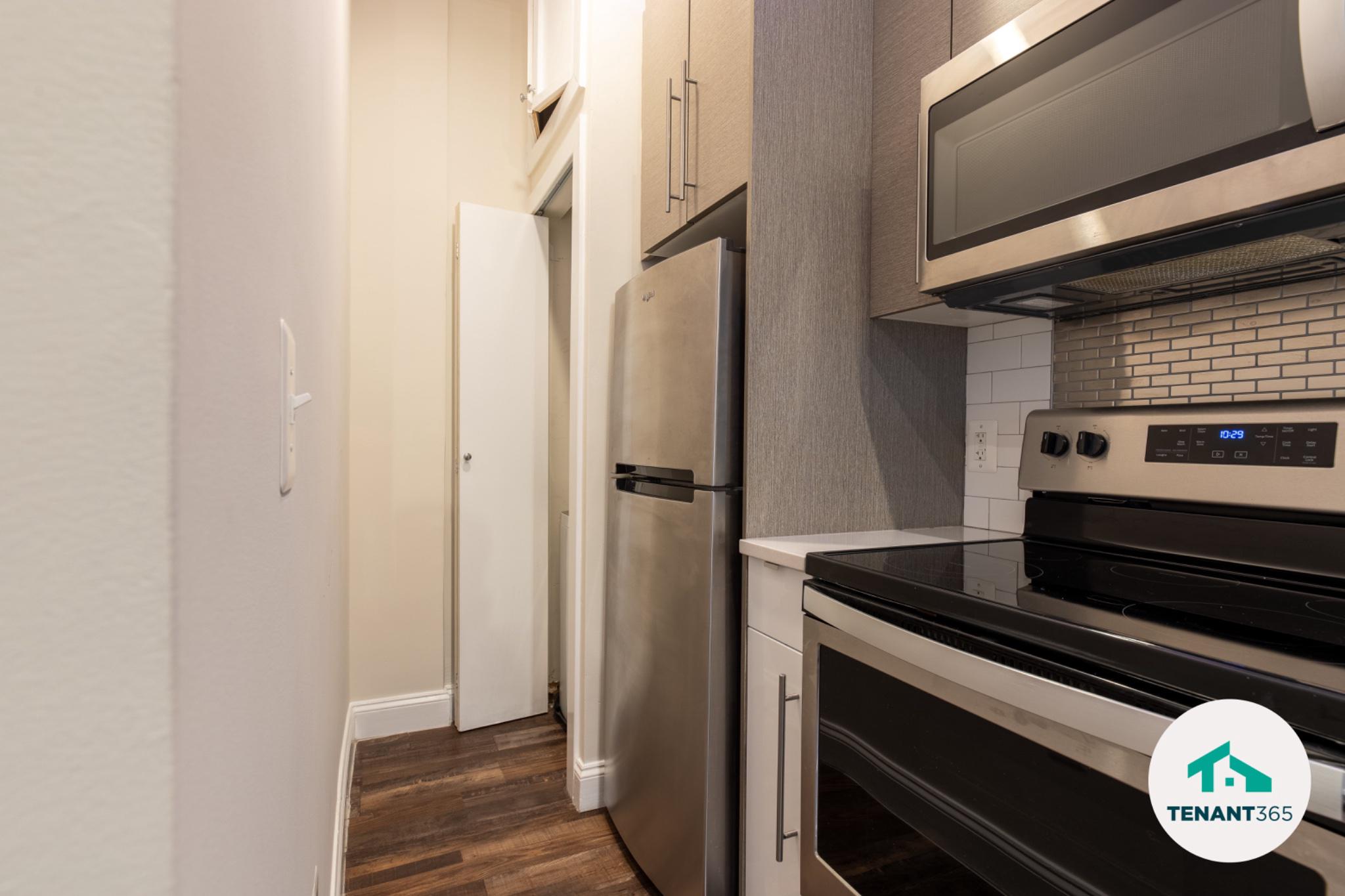 8 East Fayette Street, Unit 201 Baltimore, MD 21202 - Photo 14 of 14 Modern kitchen with laundry closet..