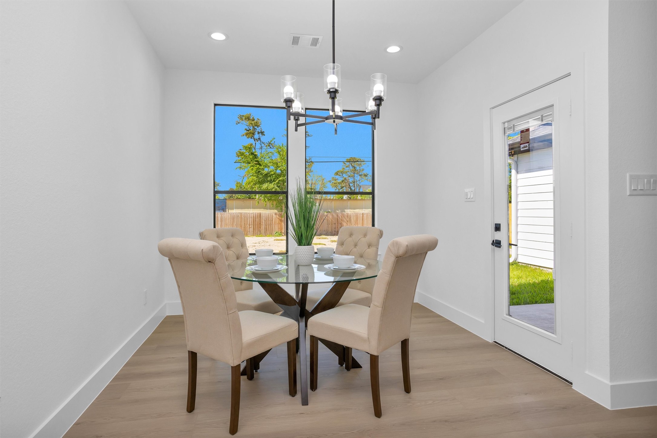 6334 Roughlock Street Houston, TX 77016 - Photo 11 of 24 a view of a dining room with furniture a rug and wooden floor