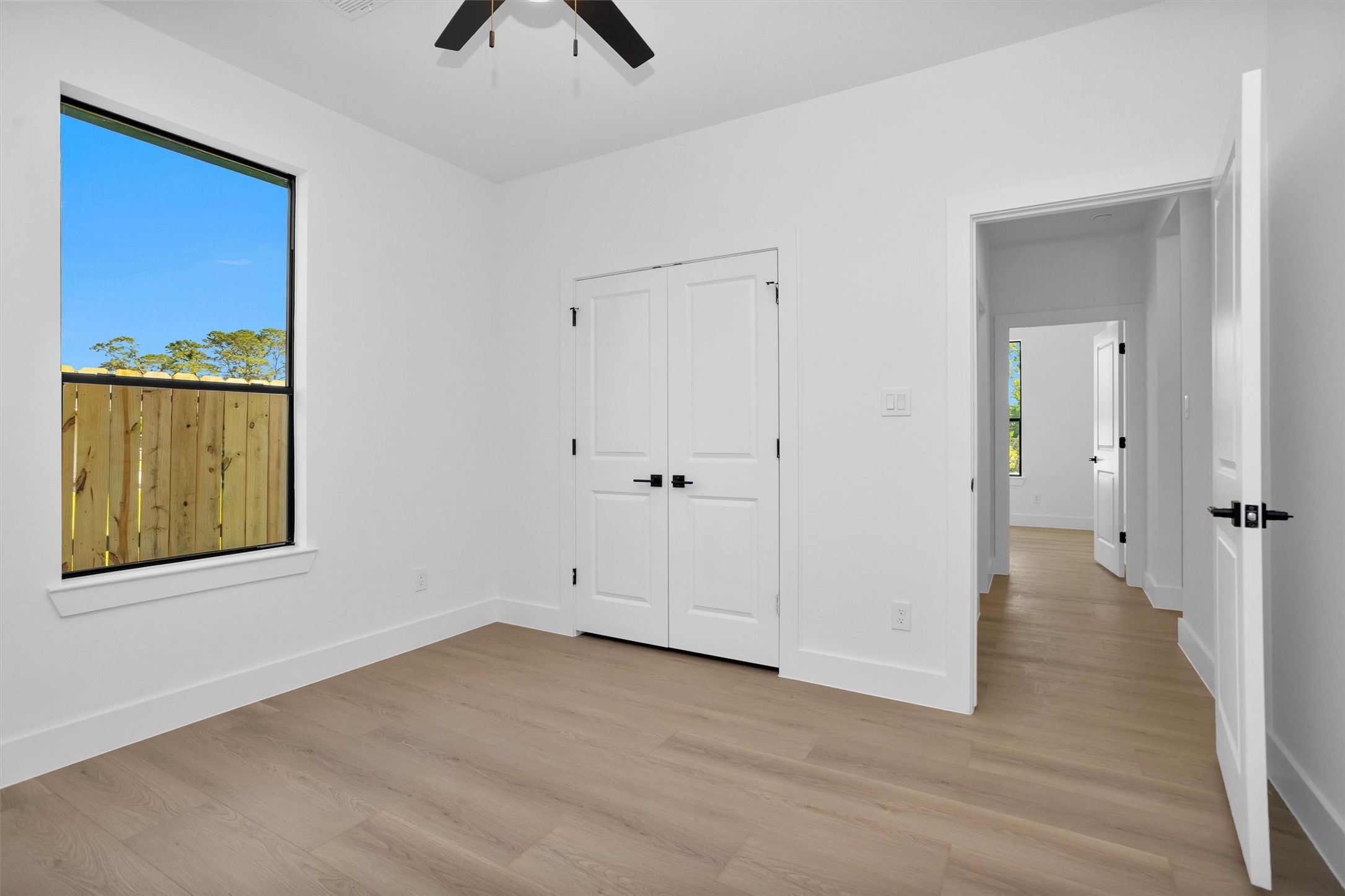 6334 Roughlock Street Houston, TX 77016 - Photo 14 of 24 wooden floor in an empty room and a window
