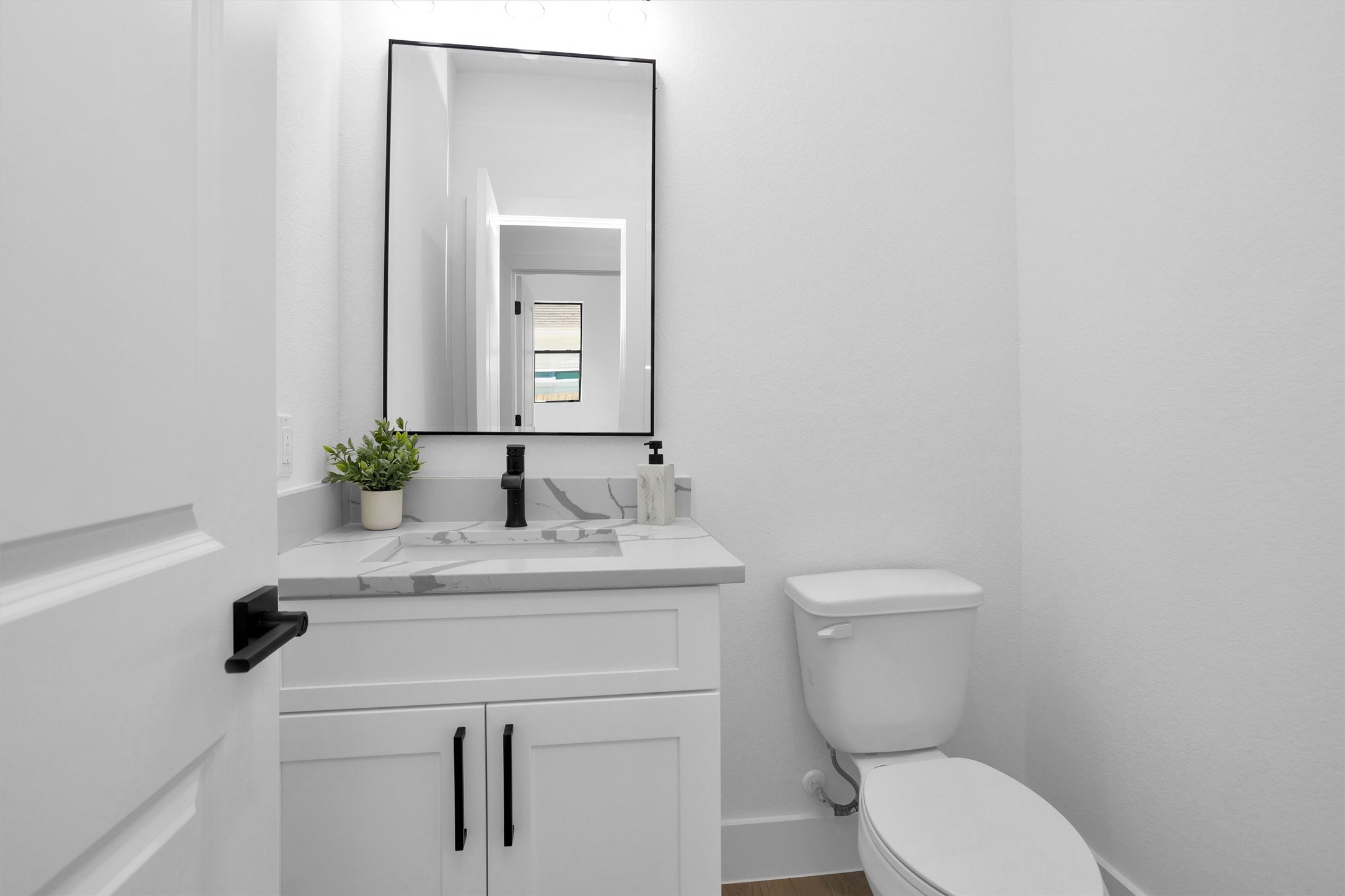 6334 Roughlock Street Houston, TX 77016 - Photo 15 of 24 a bathroom with a toilet sink and mirror