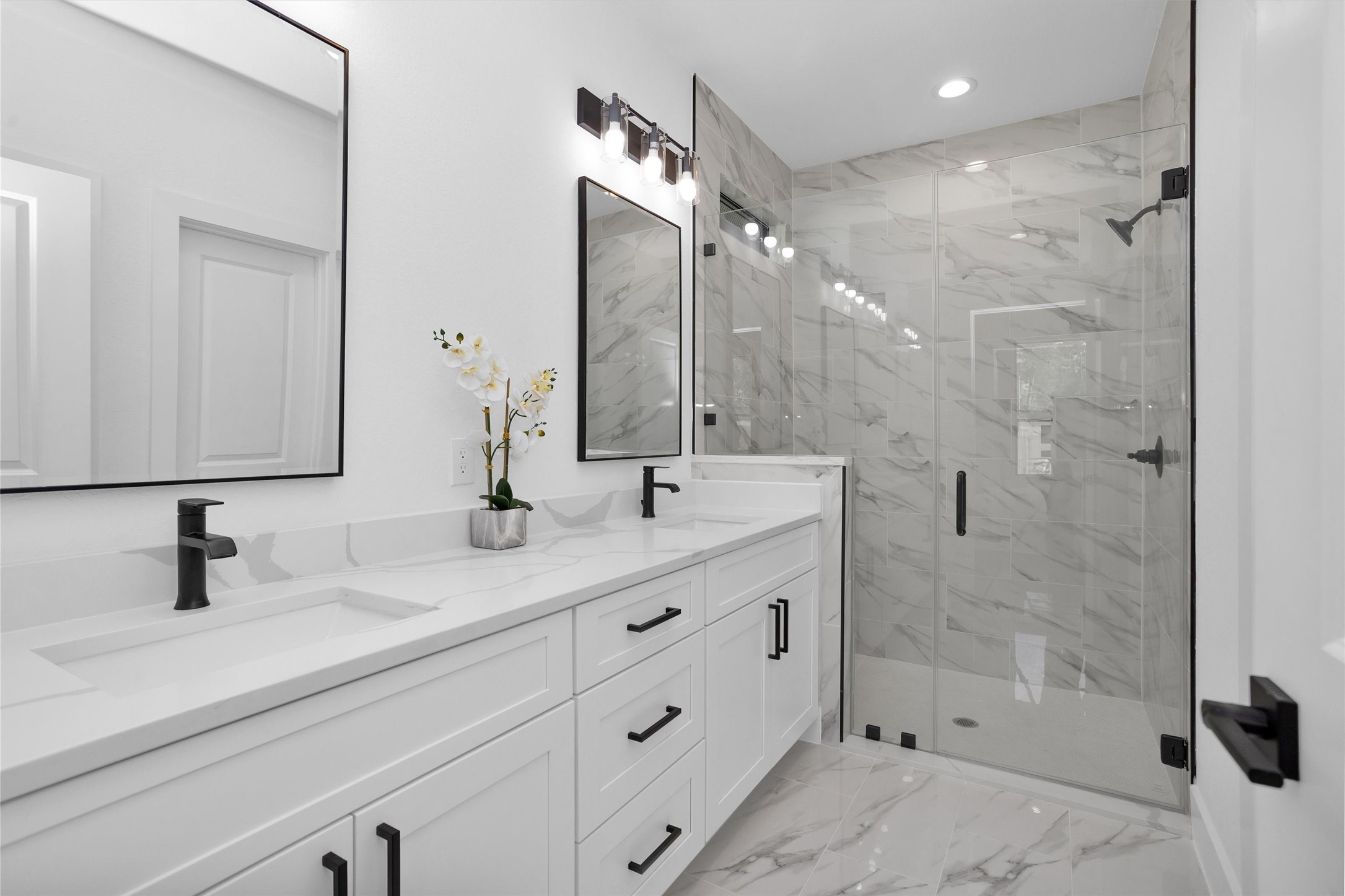 6334 Roughlock Street Houston, TX 77016 - Photo 19 of 24 a bathroom with a double vanity sink mirror double and shower