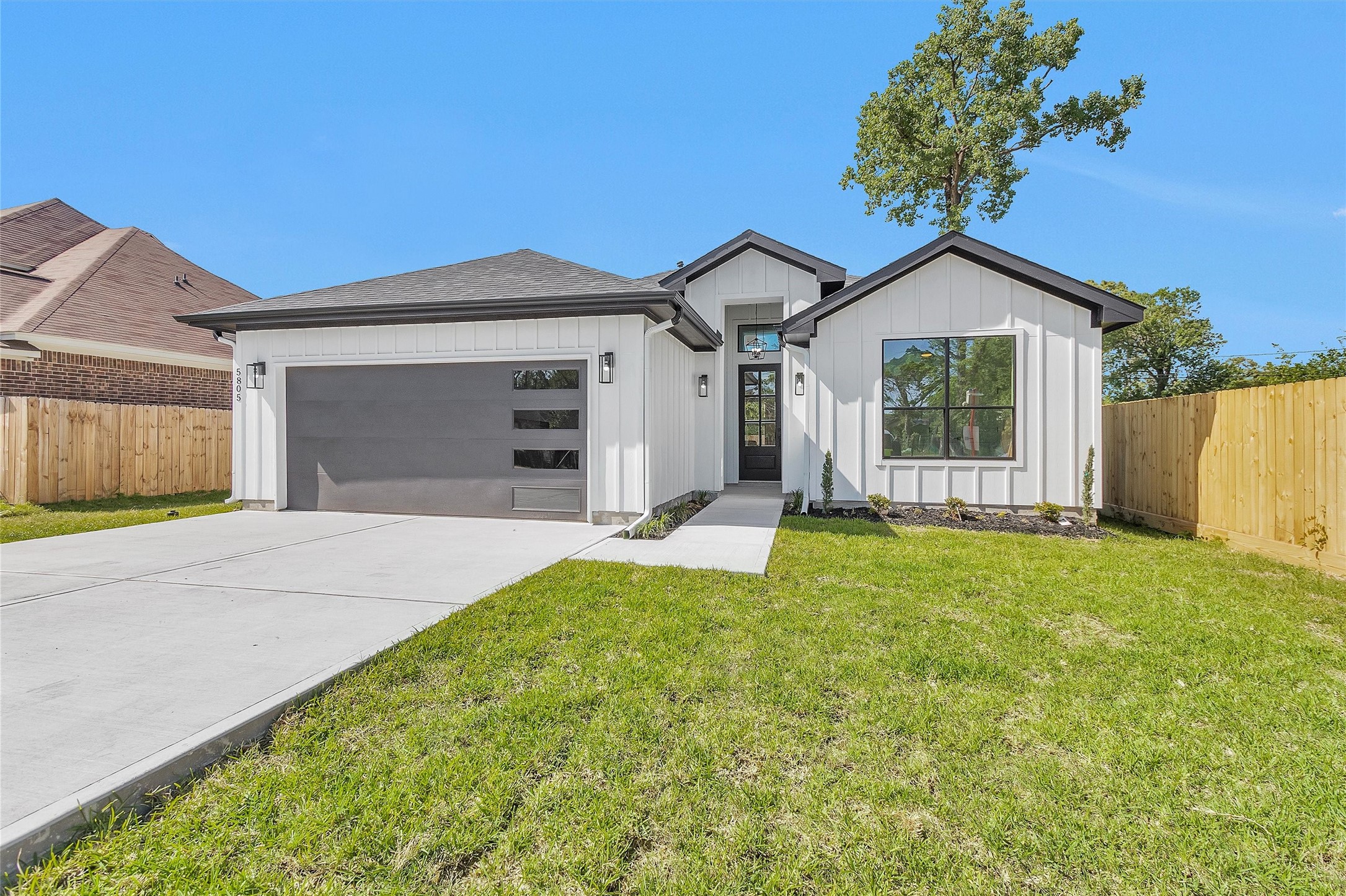 6334 Roughlock Street Houston, TX 77016 - Photo 2 of 24 a front view of a house with a yard and garage