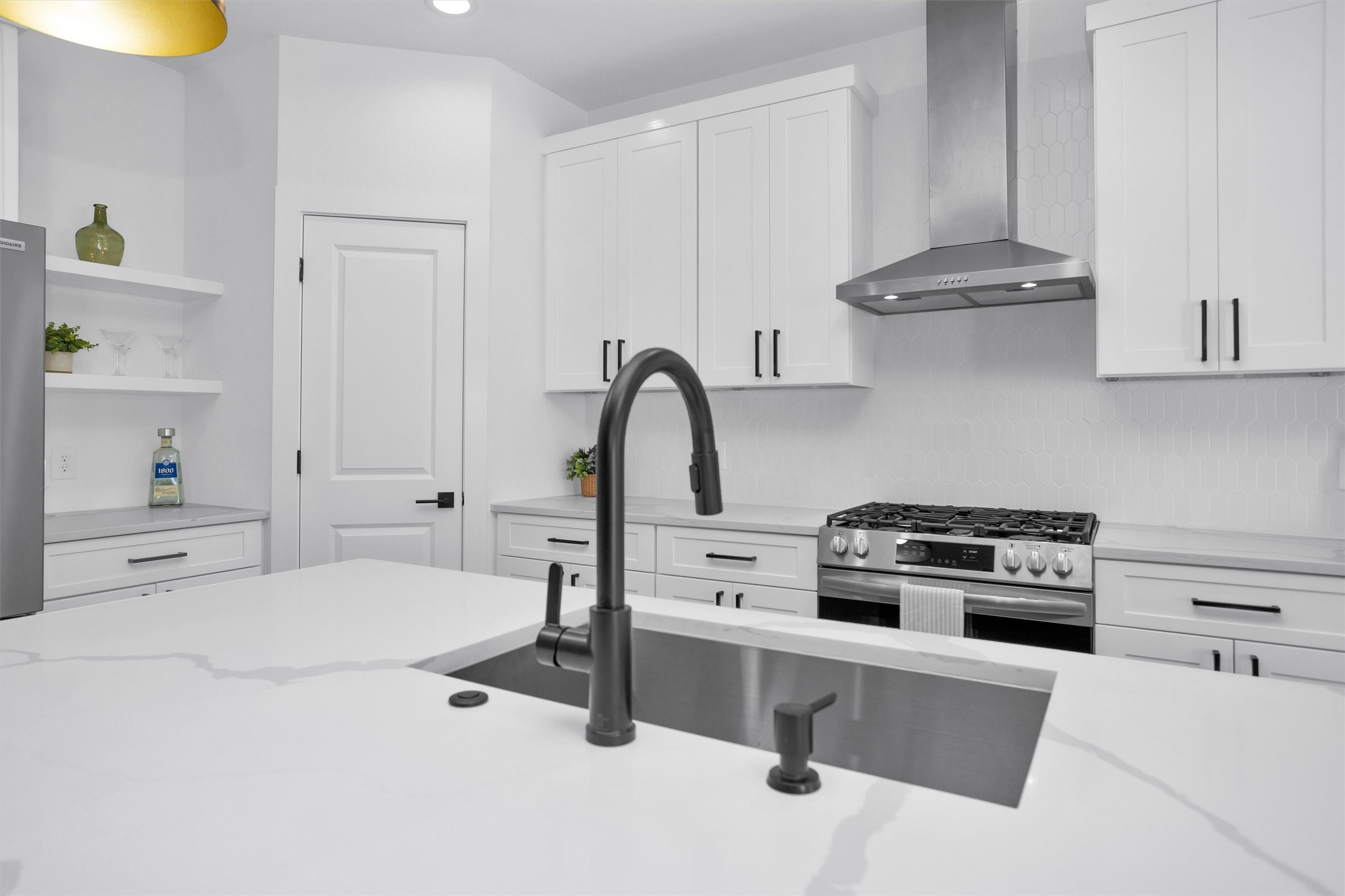 6334 Roughlock Street Houston, TX 77016 - Photo 8 of 24 a kitchen with a stove a sink and a refrigerator