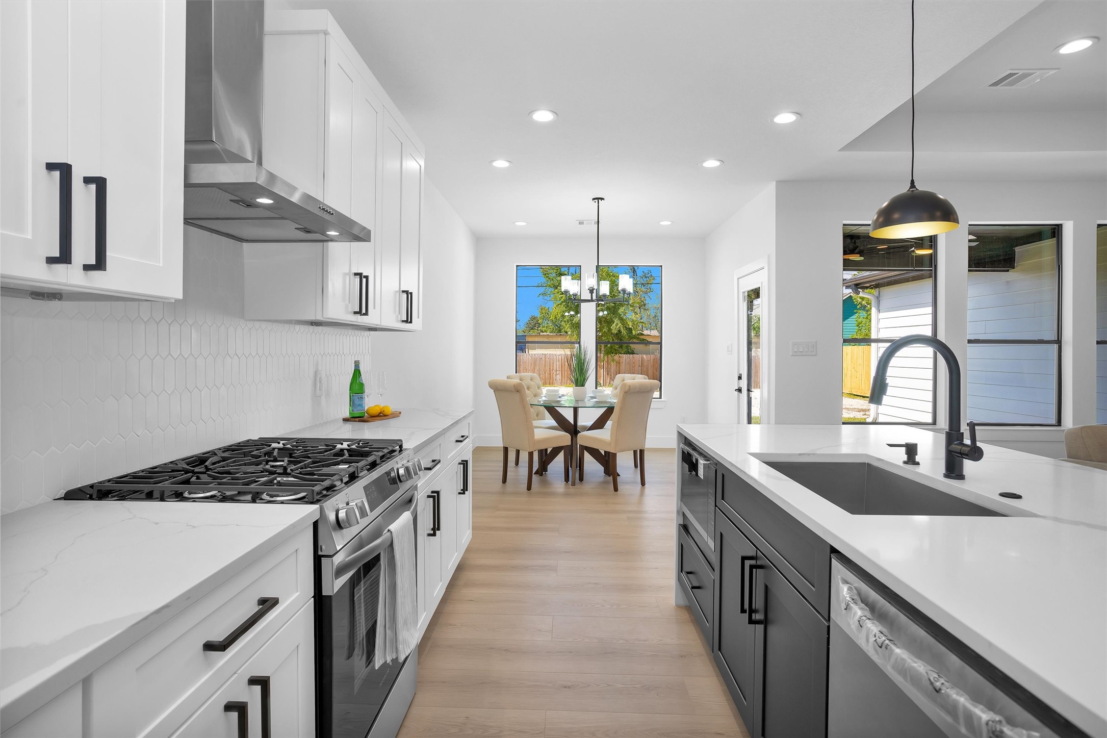 6334 Roughlock Street Houston, TX 77016 - Photo 10 of 24 a kitchen with kitchen island stainless steel appliances a sink a counter top space stove and cabinets