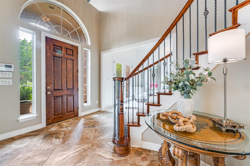 2841 Winding Creek Road Prosper, TX 75078 - Photo 14 of 40 a dining room with wooden floor and stairs