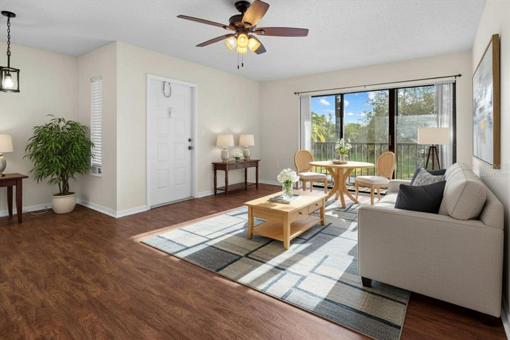 1127 Pine Ridge Circle West, Unit A2 Tarpon Springs, FL 34688 - Photo 2 of 18 a living room with furniture and a potted plant