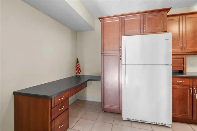 a kitchen with a refrigerator and a refrigerator