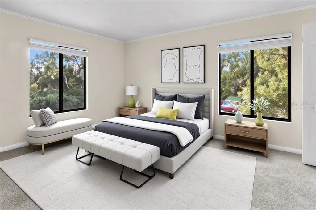 1127 Pine Ridge Circle West, Unit A2 Tarpon Springs, FL 34688 - Photo 8 of 18 a spacious bedroom with a bed and glass window