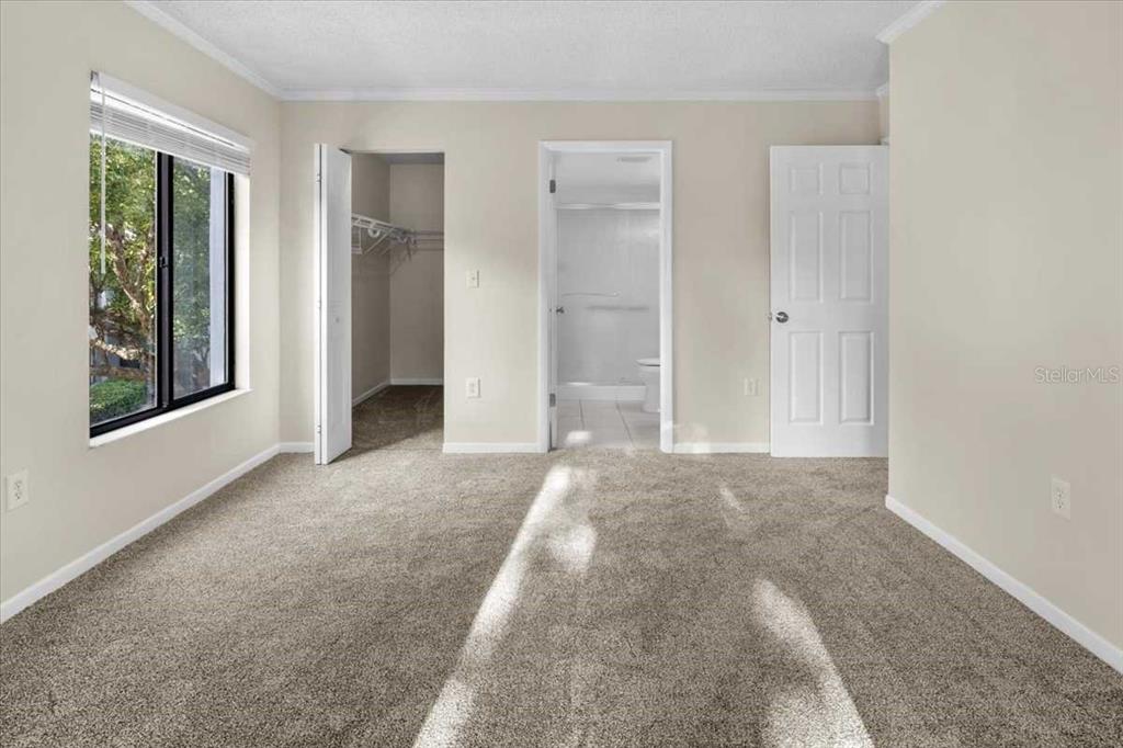 1127 Pine Ridge Circle West, Unit A2 Tarpon Springs, FL 34688 - Photo 9 of 18 an empty room with windows and closet