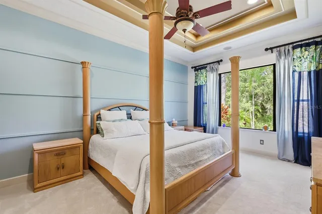 a bedroom with a bed and large window