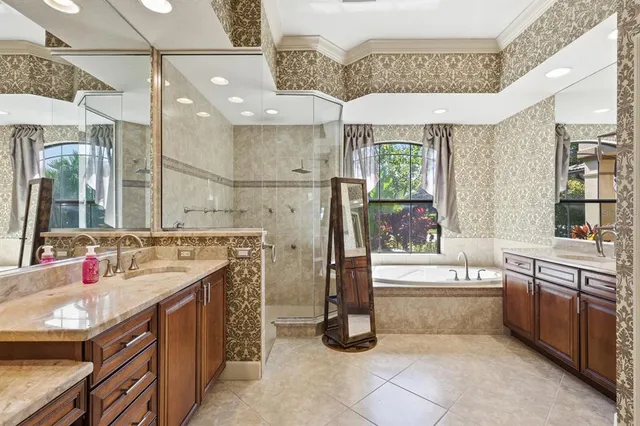 a bathroom with a tub sink and mirror