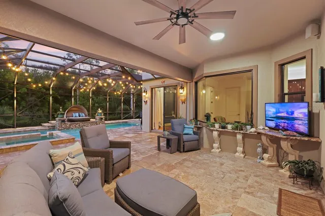 a living room with patio furniture and a flat screen tv