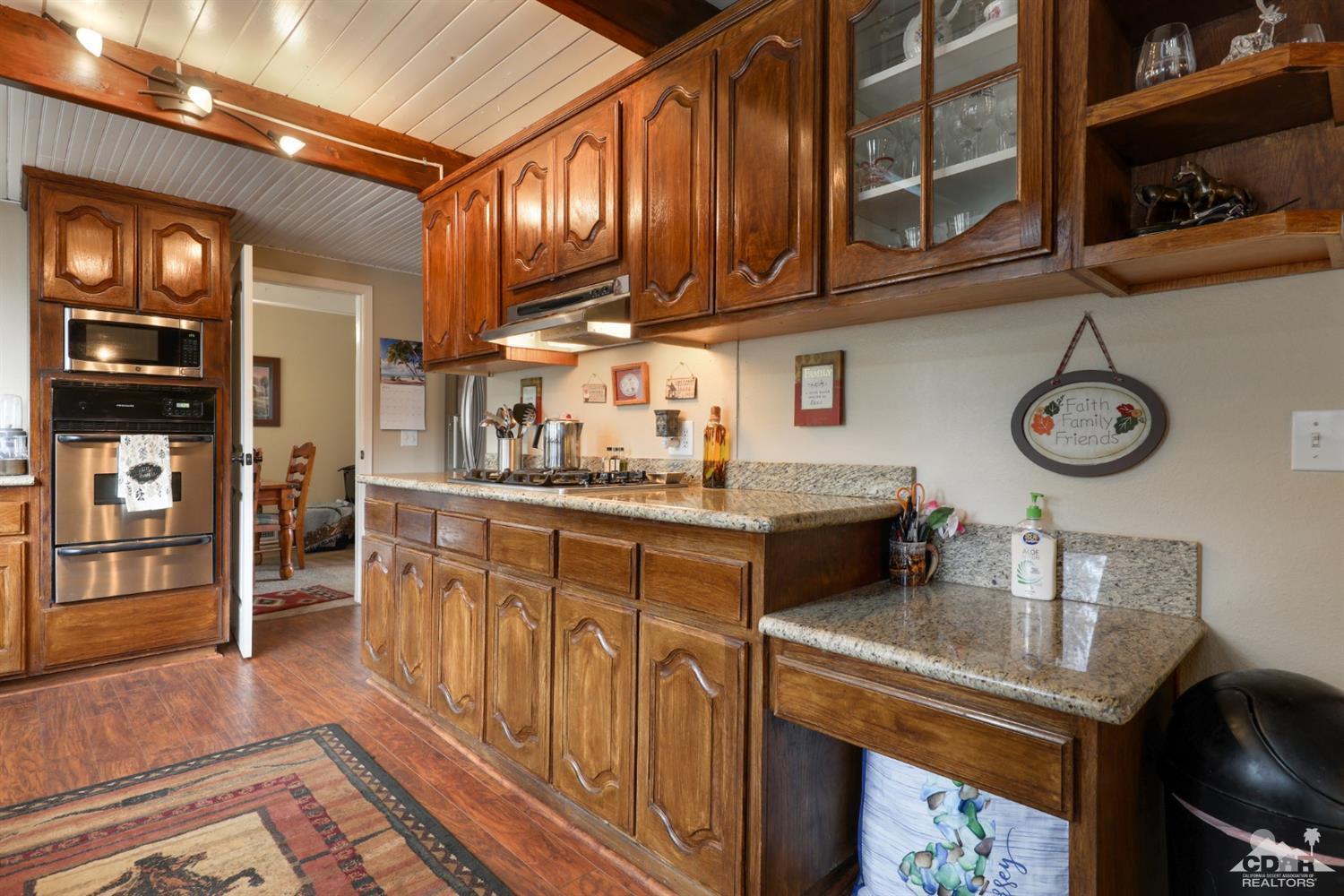 59967 Devils Ladder Road Mountain Center, CA 92561 - Photo 14 of 30 a kitchen with a stove oven and cabinets