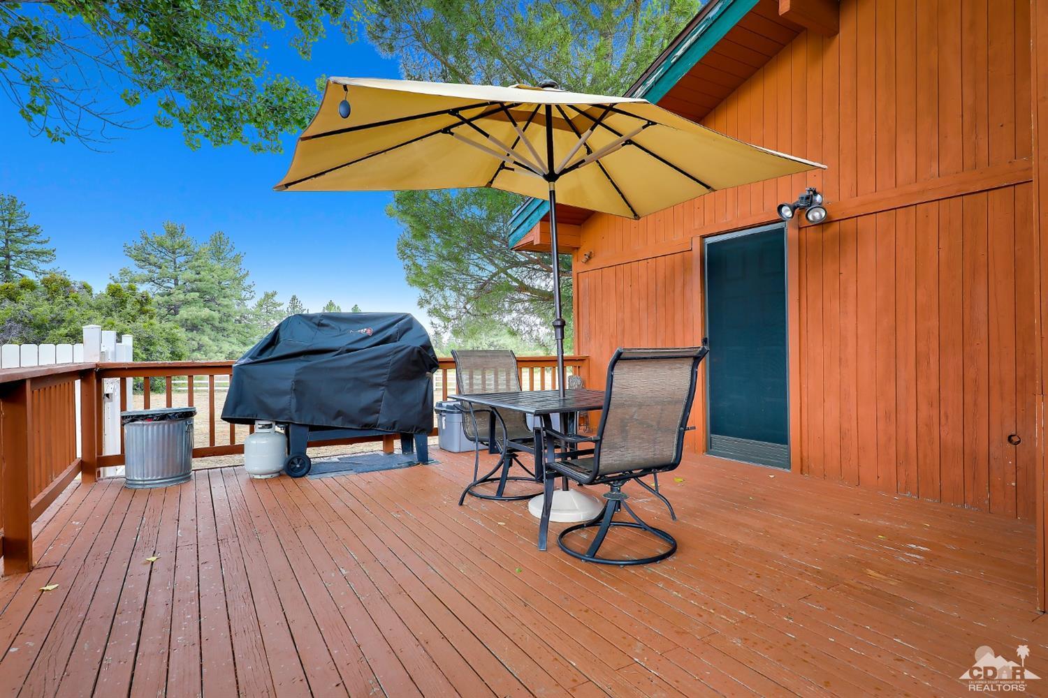 59967 Devils Ladder Road Mountain Center, CA 92561 - Photo 22 of 30 a view of balcony with furniture and wooden floor