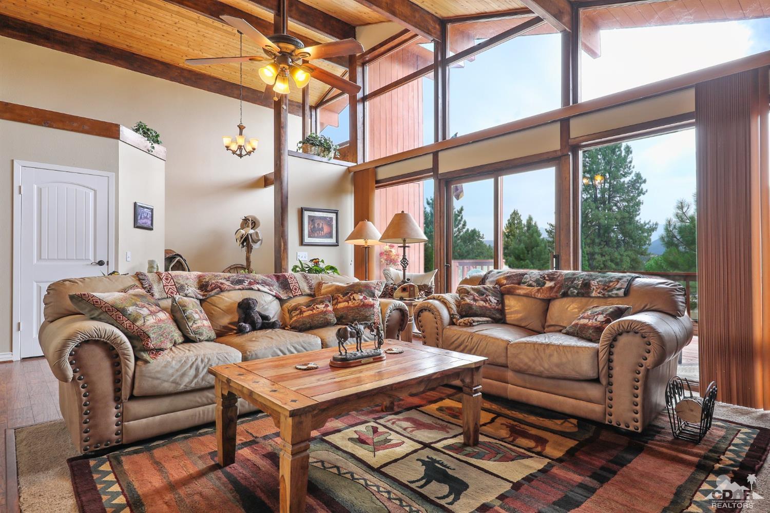 59967 Devils Ladder Road Mountain Center, CA 92561 - Photo 8 of 30 a living room with furniture and a large window