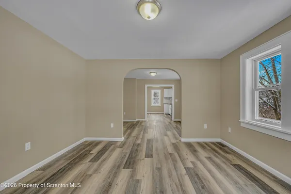 a view of a room with wooden floor and window