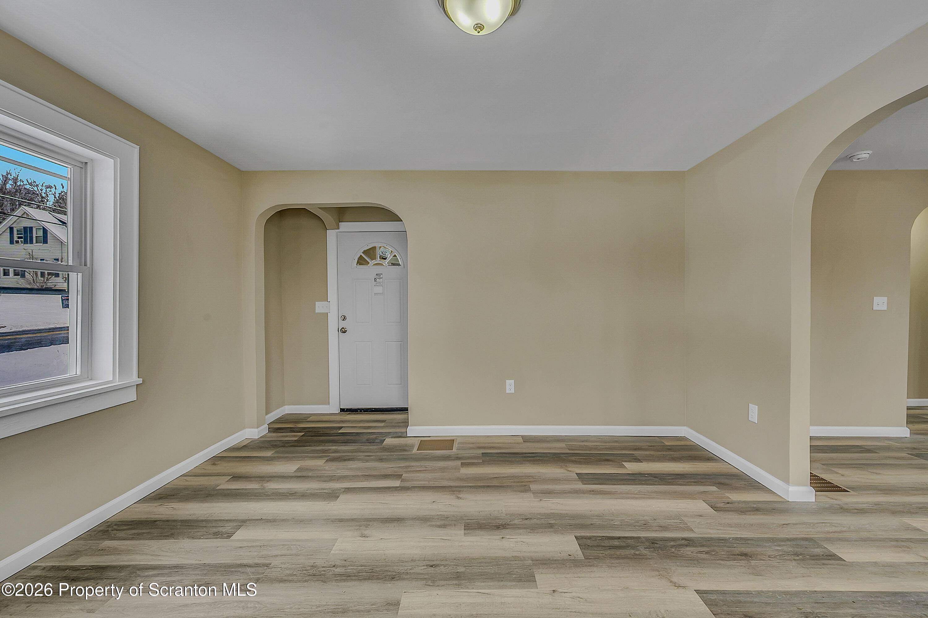 642 Bodle Road Wyoming, PA 18644 - Photo 12 of 33 a view of a livingroom with wooden floor and a window