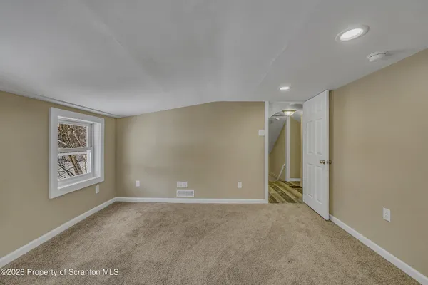 a view of an empty room with a window