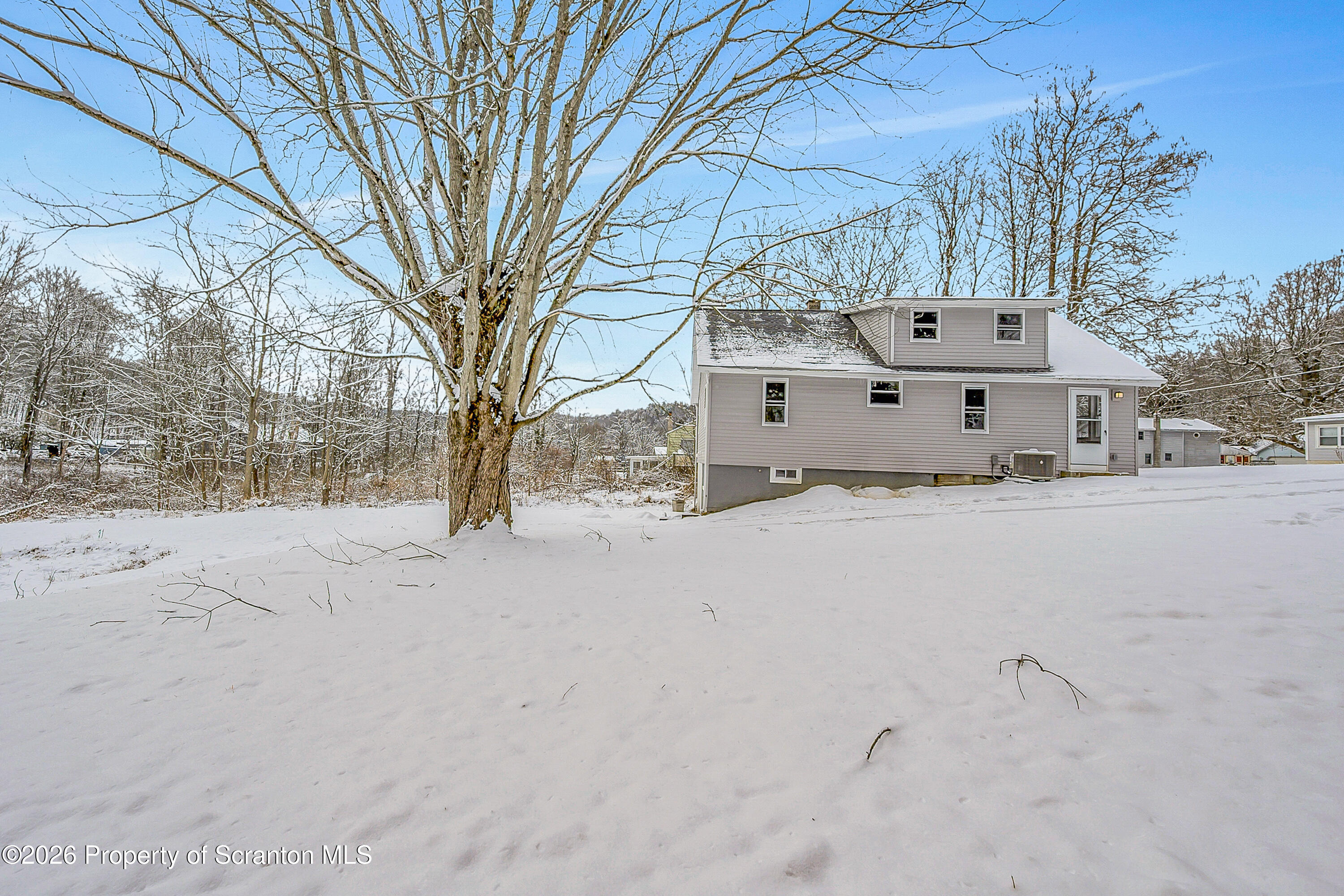 642 Bodle Road Wyoming, PA 18644 - Photo 4 of 33 a front view of house with a yard covered in snow