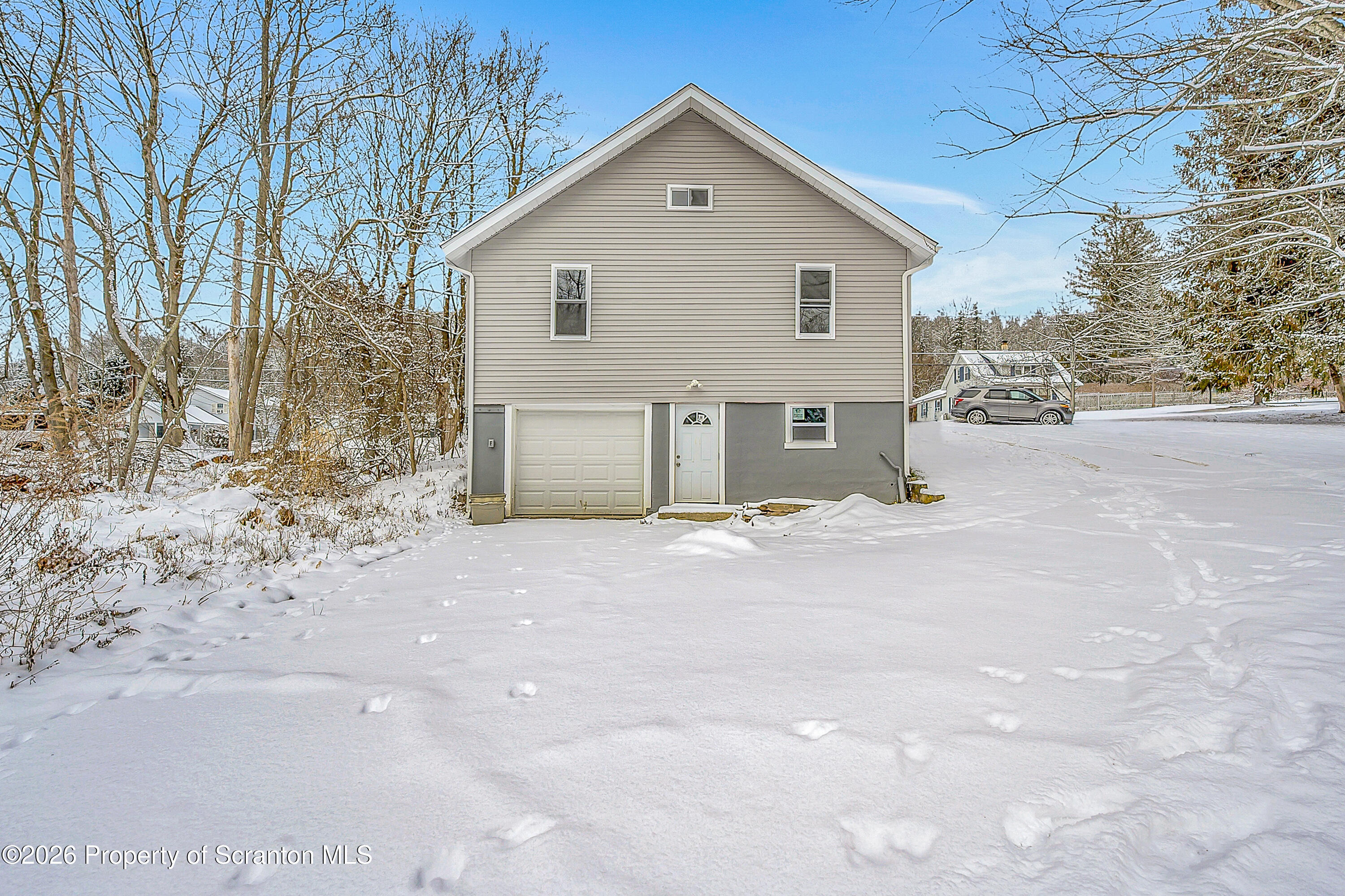 642 Bodle Road Wyoming, PA 18644 - Photo 6 of 33 a view of a house with a yard covered in snow