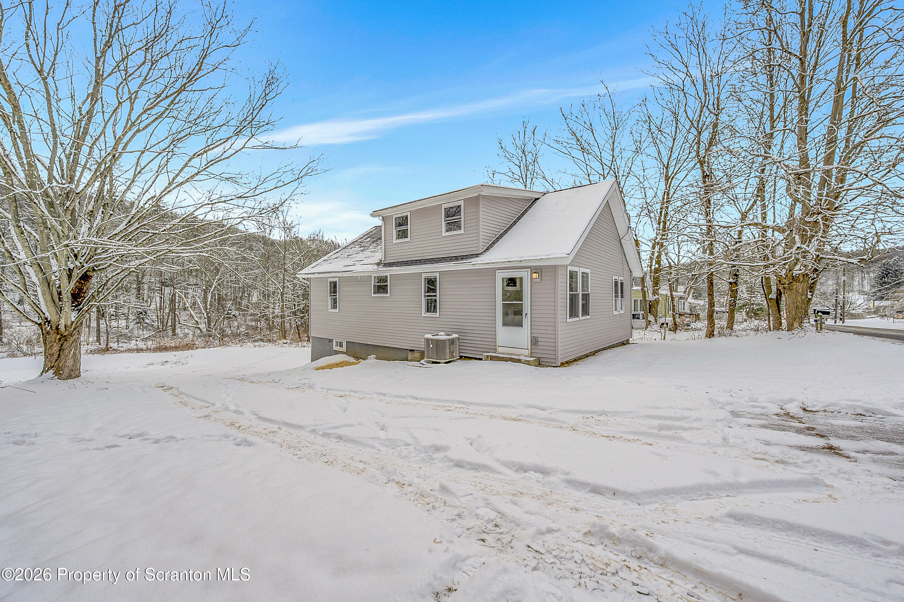 642 Bodle Road Wyoming, PA 18644 - Photo 7 of 33 a front view of a house with a yard covered in snow