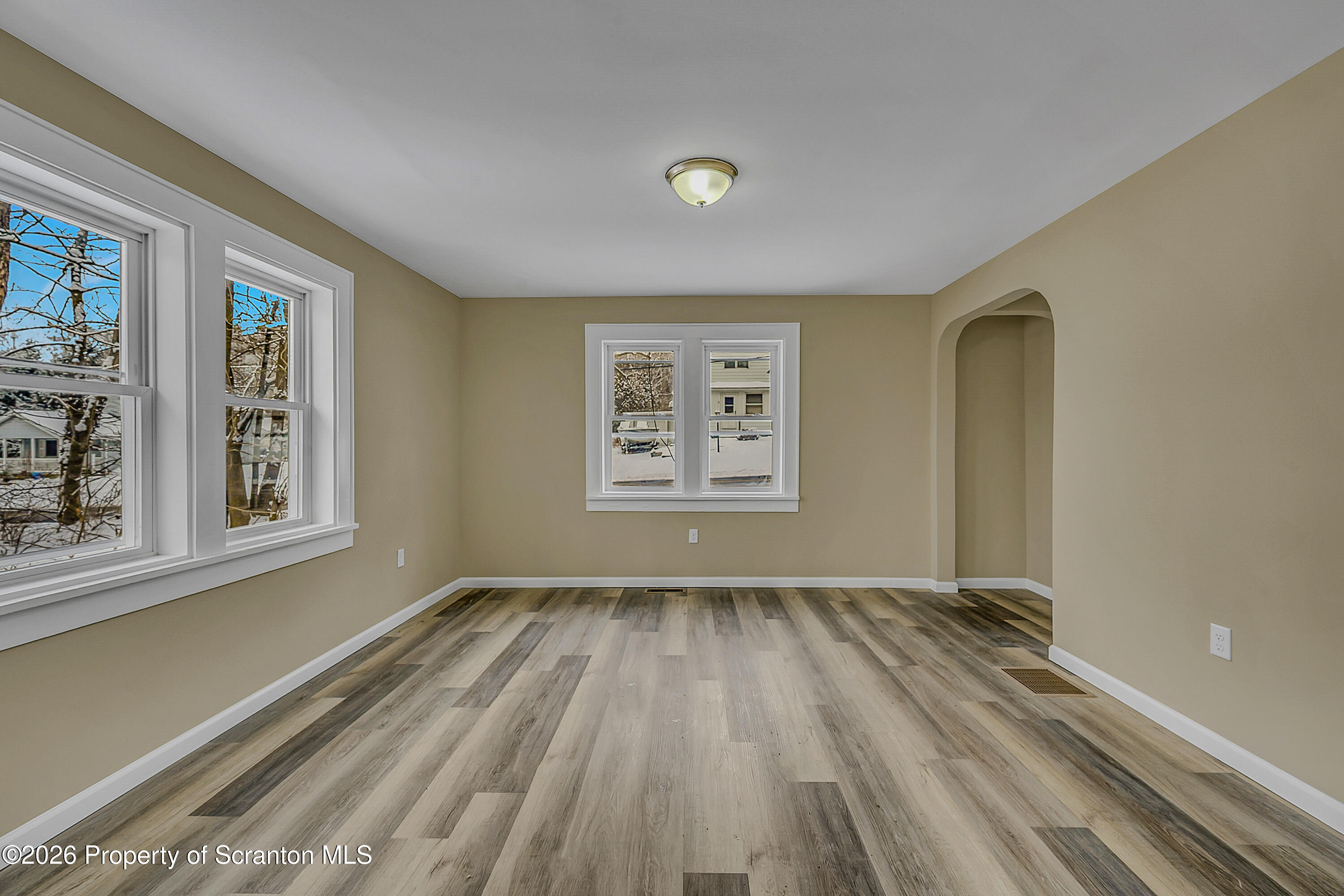 642 Bodle Road Wyoming, PA 18644 - Photo 10 of 33 a view of an empty room with a window and wooden floor