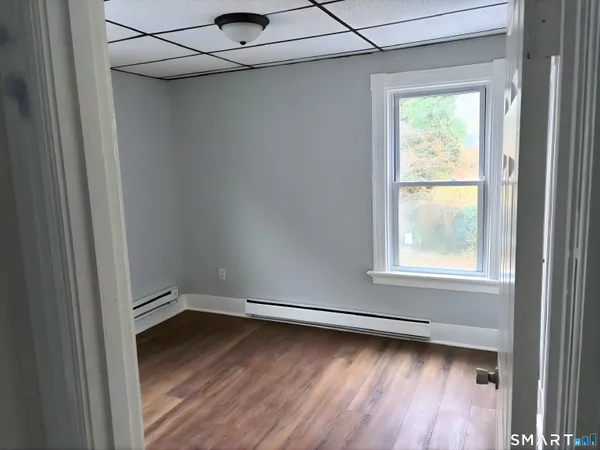 a view of a room with wooden floor and windows