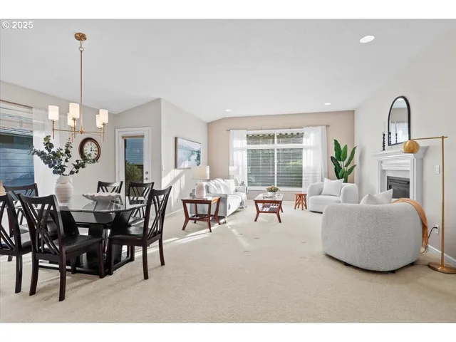 a living room with furniture chandelier and a fireplace