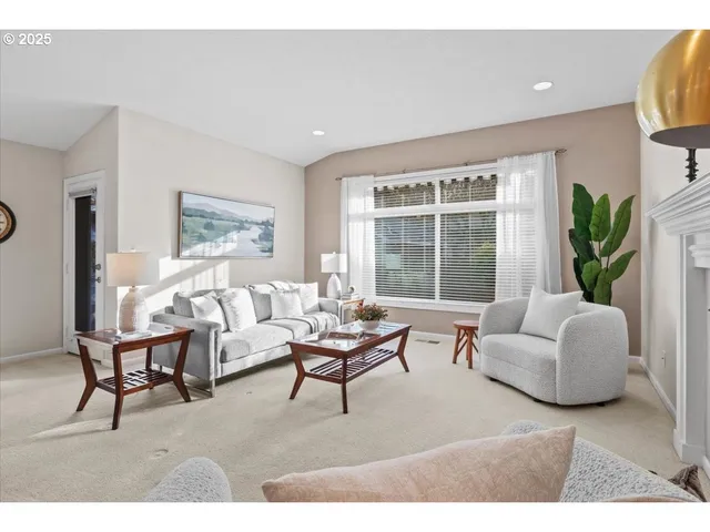 a living room with furniture and a large window