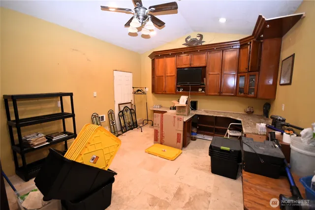 a view of a house with a yard and wooden fence