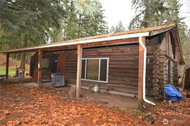 a view of backyard with chairs and a yard
