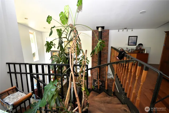a dining hall with stainless steel appliances granite countertop a sink dishwasher and a computer on a table with the kitchen view