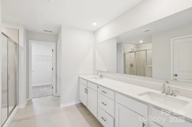 a spacious bathroom with a double vanity sink mirror and