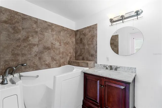 a bathroom with a sink a toilet and mirror