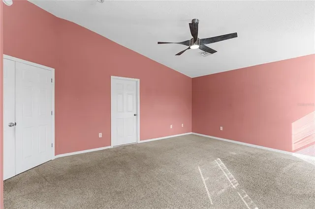 a view of a livingroom with a ceiling fan and window
