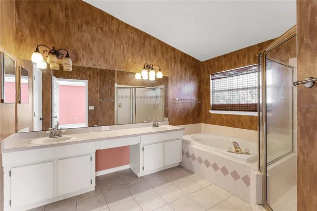 a bathroom with a tub sink and mirror