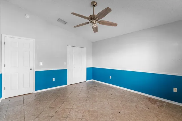 a view of room with window and ceiling fan